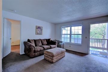 Kansas City apartment for rent - a living room with a couch and a ottoman in front of a window