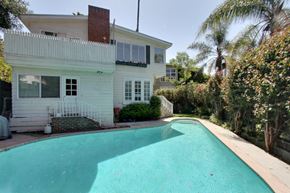Los Angeles apartment for rent - a large pool in front of a white house