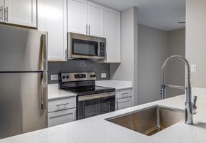 Palatine apartment for rent - a kitchen with stainless steel appliances and white cabinets
