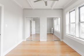 Chicago apartment for rent - an empty living room with wood floors and white walls