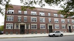 Chicago apartment for rent - a white car parked in front of a brick building