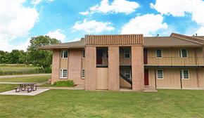 Bartlesville apartment for rent - an apartment building with a picnic table in front of it