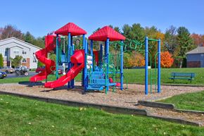 Ballston Spa apartment for rent - a playground with a red and blue play set in a park