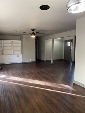 Denton house for rent - A room with a ceiling fan and a door.