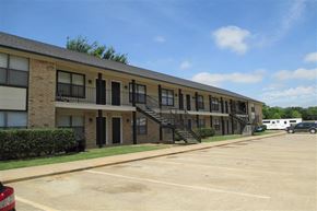 Aubrey apartment for rent - an apartment building with a parking lot and stairs