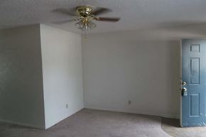 Aubrey apartment for rent - an empty room with a ceiling fan and a blue door