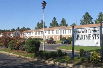 Dublin apartment for rent - Groveland Terrace Apartments is a large apartment complex with a parking lot in front.