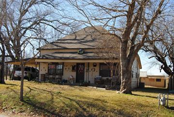 Aubrey house for rent - the front of a house with a yard and trees