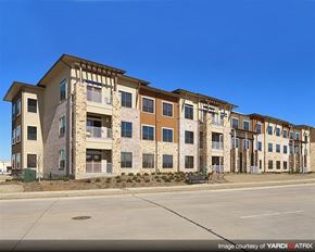 Denton apartment for rent - A row of modern apartment buildings with balconies and multiple windows.