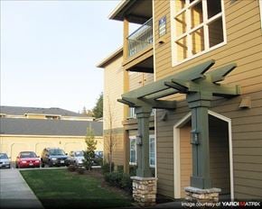 Gresham apartment for rent - A building with a carport and a covered walkway.