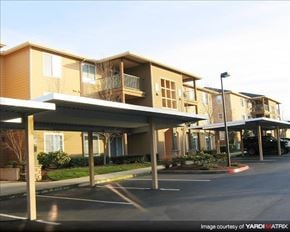 Gresham apartment for rent - A parking lot is in front of a building with a canopy.