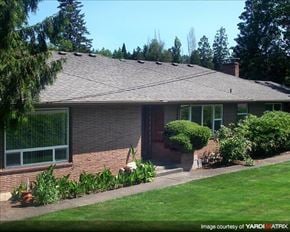 Portland apartment for rent - A house with a brown roof and a green lawn in front.