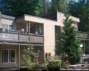 Portland apartment for rent - A house with a balcony and a tree in front.