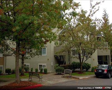 Clackamas apartment for rent - A tree with red leaves stands in front of a building.