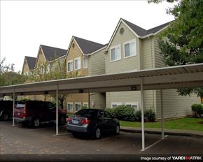 Clackamas apartment for rent - A carport with two cars parked in front of a house.