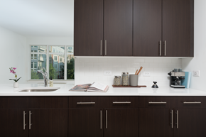 Harrison apartment for rent - a kitchen with dark cabinets and a sink and a window