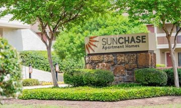Ridgeland apartment for rent - a sign for the sun chase apartment homes in front of trees and bushes