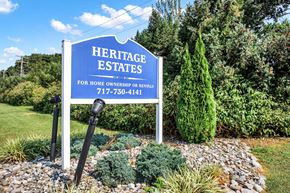 New Providence apartment for rent - A sign for Heritage Estates is displayed in front of a well-manicured garden.