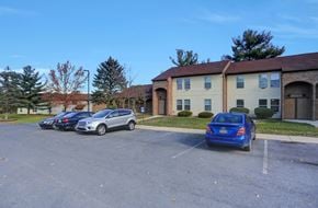 Shippensburg apartment for rent - a parking lot with cars in front of a building