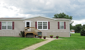 Dover apartment for rent - A house with a grey siding and red window frames.