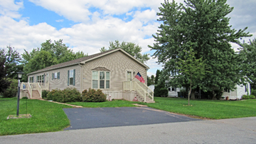 Dover apartment for rent - A house with a flag on it is surrounded by trees.