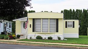 Ephrata apartment for rent - A yellow house with a flag on the front.
