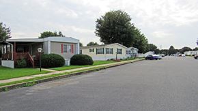 Ephrata apartment for rent - A street view of a residential area with houses and parked cars.