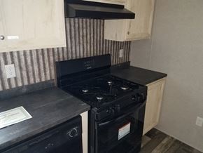 Drums apartment for rent - A black stove top oven with a paper on the counter.