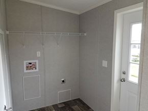 Drums apartment for rent - A room with a door, a window, and a wall with a few pictures and a shelf.