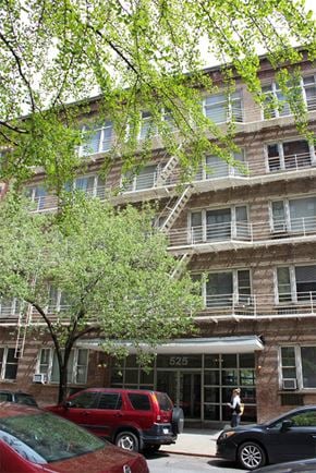 New York apartment for rent - an apartment building with cars parked in front of it