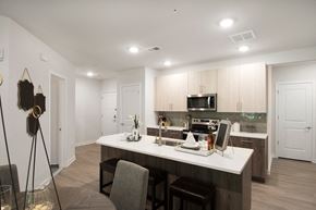 Allentown apartment for rent - an open kitchen and dining area with a white counter top and a white kitchen island