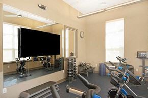 Allentown apartment for rent - a gym with weights and a tv on the wall