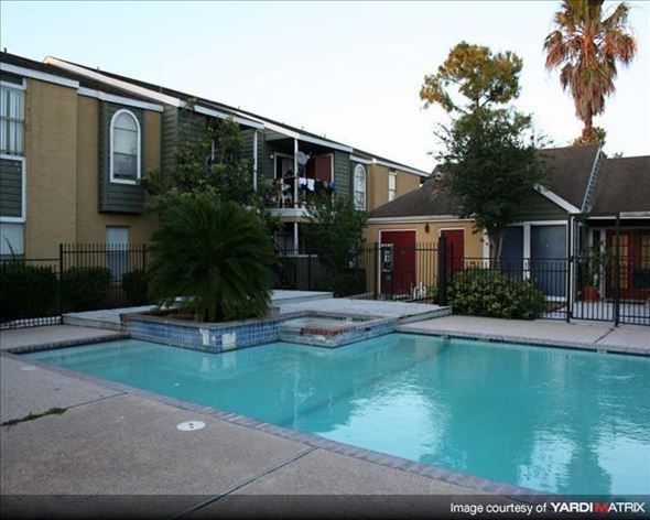 Houston apartment for rent - a swimming pool in front of an apartment building