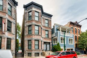 Chicago apartment for rent - a red car parked in front of a brick building
