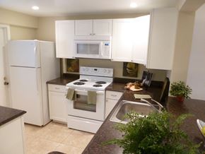 Deerfield Beach apartment for rent - a kitchen with white appliances and counter tops and a sink