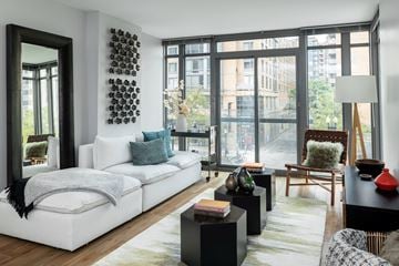 Washington apartment for rent - A modern living room with a white sofa and a black coffee table.