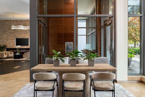 Washington apartment for rent - A modern dining room with a wooden table and chairs.