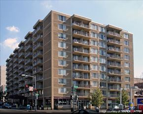Washington apartment for rent - A large apartment building with balconies on the upper floors.
