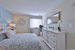 Glen Burnie apartment for rent - a bedroom with a bed and dresser and a mirror
