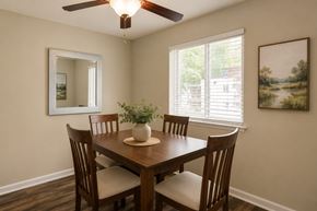 Glen Burnie apartment for rent - A dining room with a wooden table and chairs.