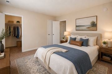 Glen Burnie apartment for rent - A bedroom with a large bed and a painting on the wall.