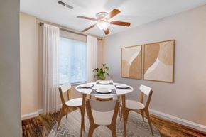 Glen Burnie apartment for rent - a dining room with a table and chairs and a ceiling fan