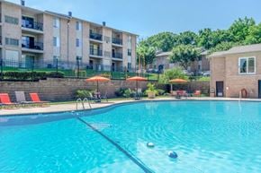 Glen Burnie apartment for rent - a large swimming pool with an apartment building in the background