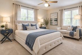 Laurel apartment for rent - A bedroom with a large bed and a ceiling fan.