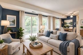 Laurel apartment for rent - A living room with a sofa, armchair, and a coffee table.