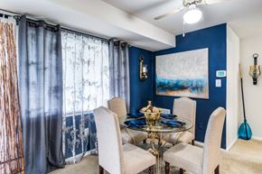 Laurel apartment for rent - A dining room with a glass table and chairs.