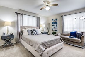 Laurel apartment for rent - A bedroom with a large bed and a couch.