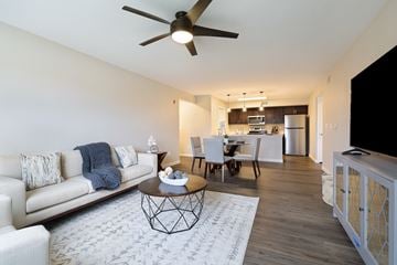 Gardner apartment for rent - A living room with a white couch and a ceiling fan.