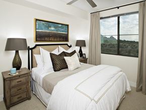 Scottsdale apartment for rent - a bedroom with a bed and a large window