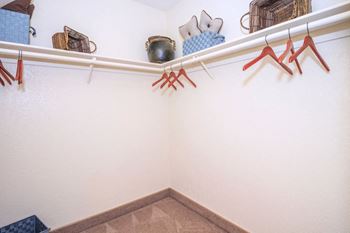 A display of clothes and shoes in a store with white walls